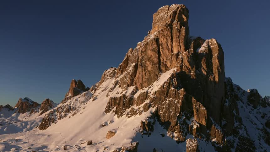 Snow covered mountains with peaks high in a clear blue sky