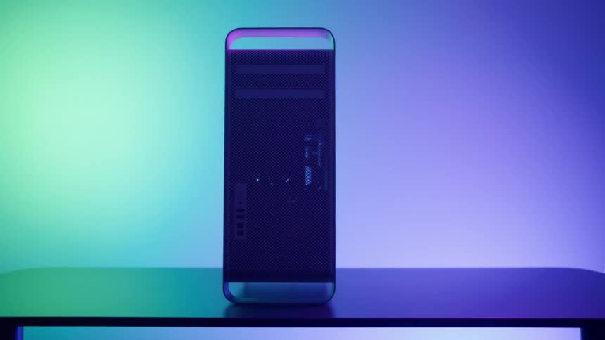 A computer tower on a table in a room with a wall and lights in the background