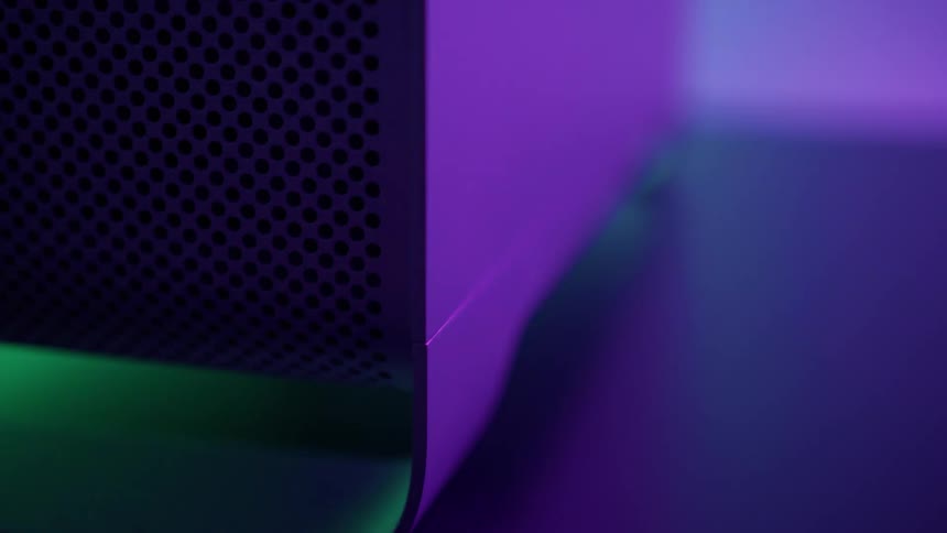 Computer over a desk surrounded by colorful strobing lights