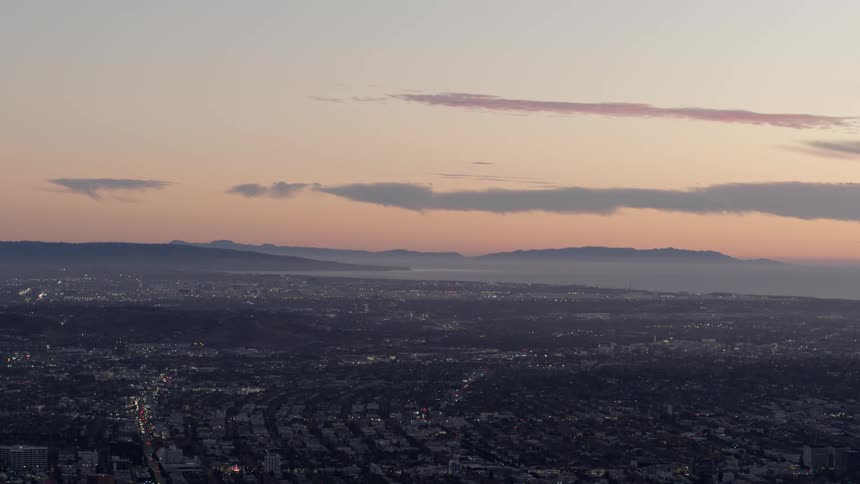 A sunset aerial shot of Palos Verdes and South Los Angeles from the perspective of Hollywood Hills
