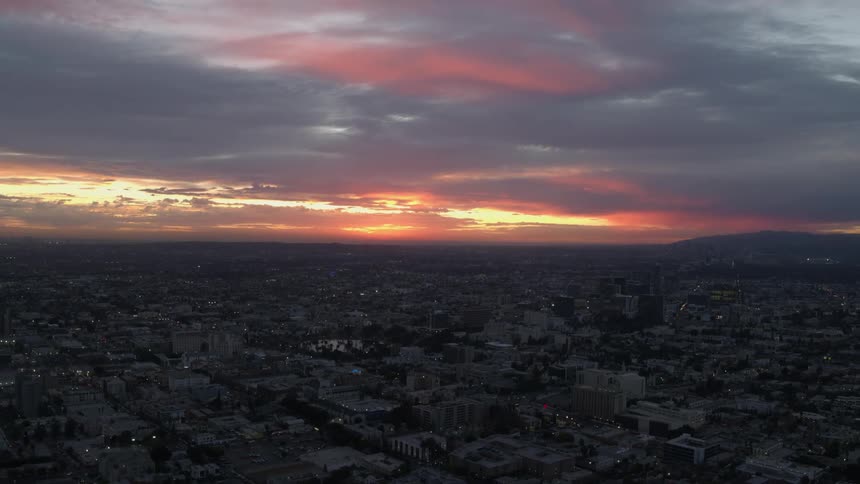 East Los Angeles sprawls out under a brilliant red sky as fog covers the horizon