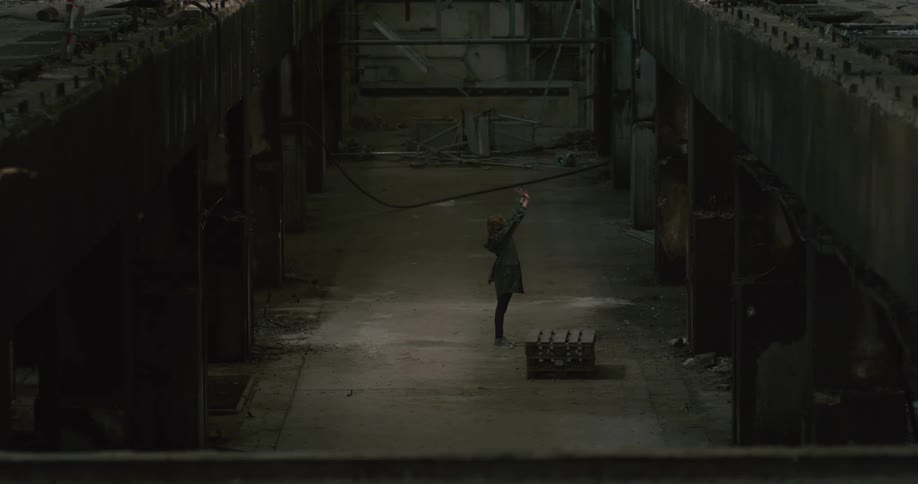 Woman dance in dimly lit abandoned building