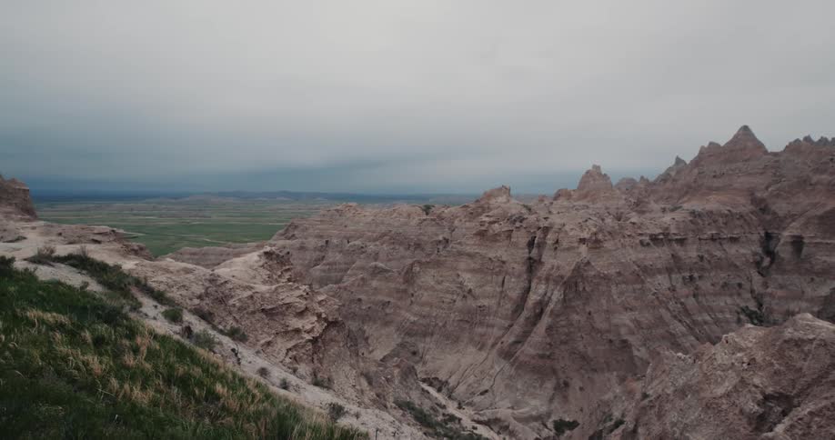 A mountain ridge with little vegetation under a cloudy daytime sky