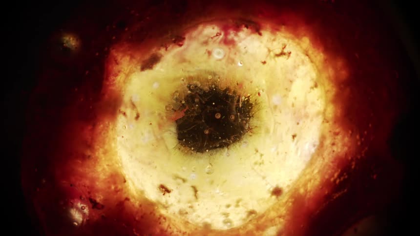 Funnel of yellow and red liquid flows to eliminate black center