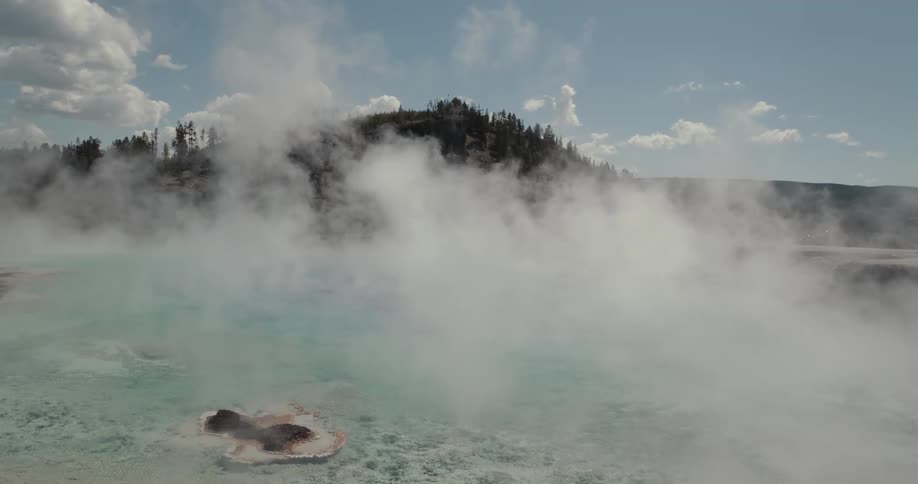A view of hot springs with steam off of it
