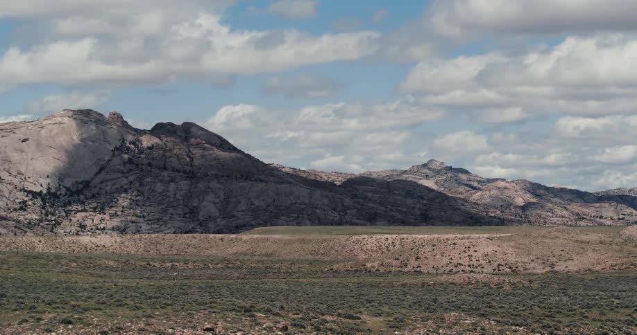 The long field leads to the mountain range