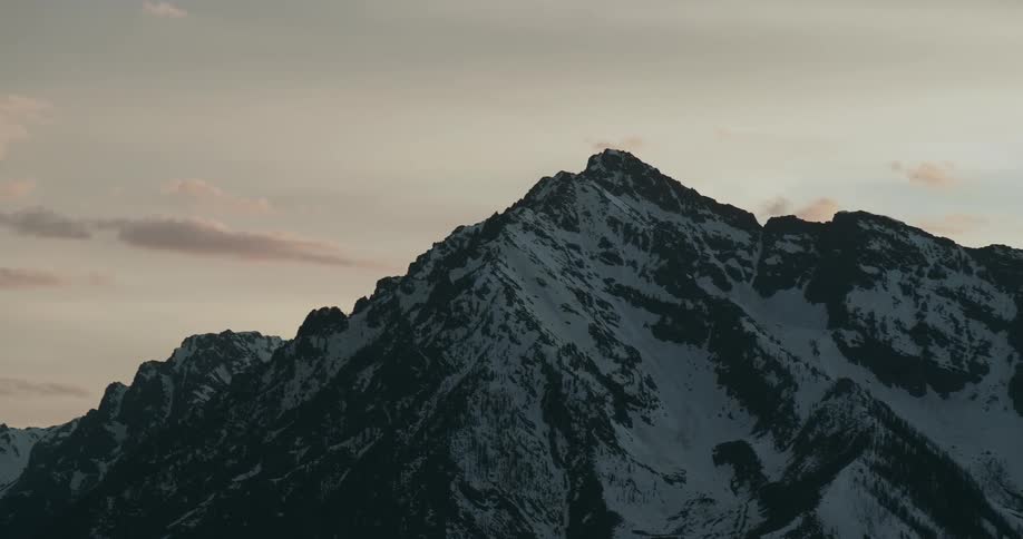 A rocky mountain ridge dusted with snow