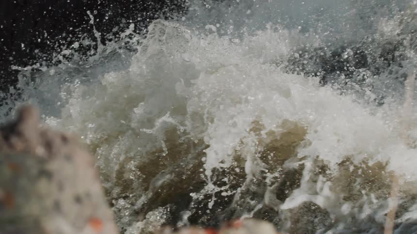 A close view of whitewater splashing and foaming in a river in the daytime