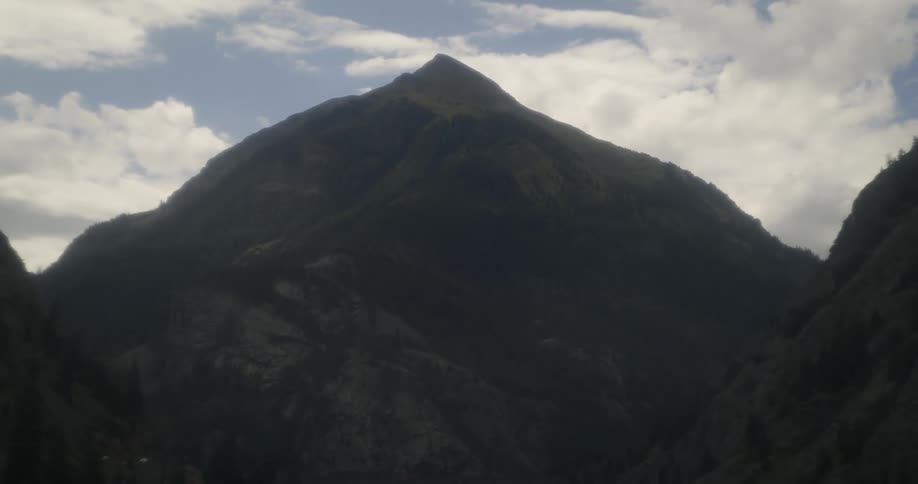 Fir trees grow up the side of mountains