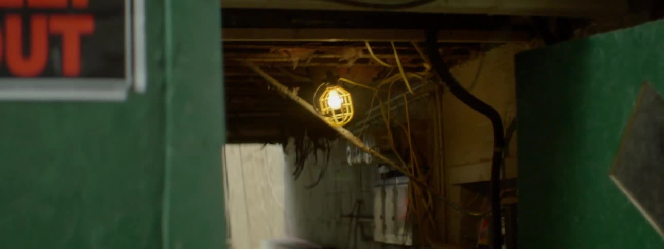 A door leads to a tunnel with one light