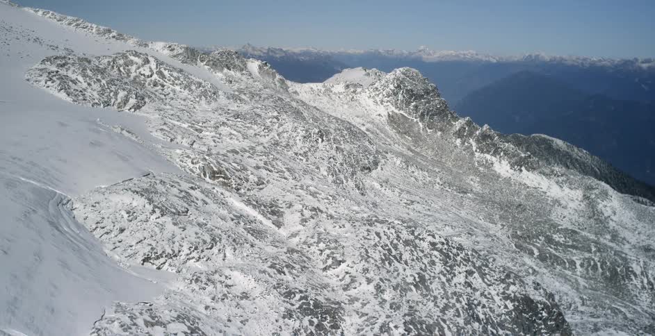 Aerial view of the snow covered slopes of a mountain range