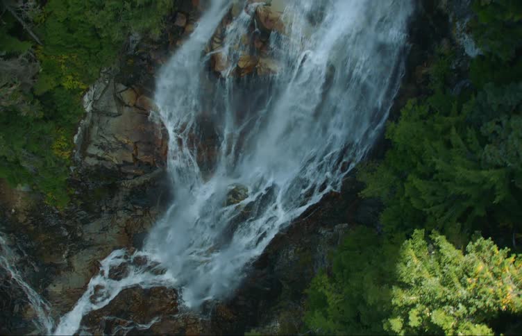 A raging waterfall pours over the mountain
