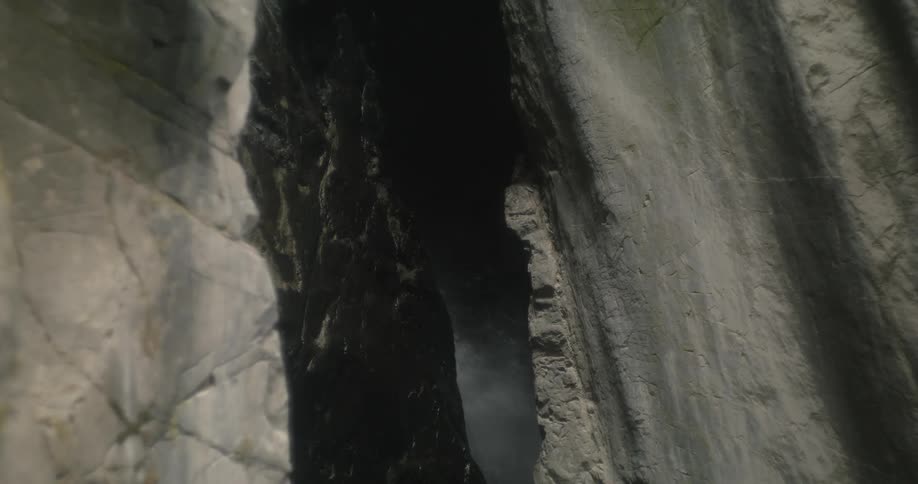 A waterfall is visible through a narrow spot between canyon walls