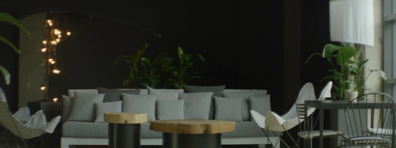 A large couch sits in a dark room