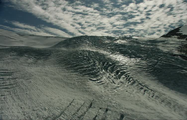 Aerial shot of a snowy rocky mountain