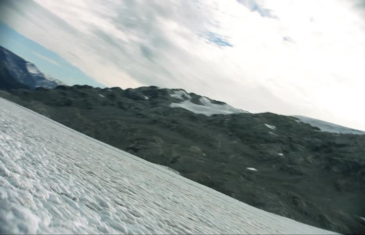 The field is covered with ice before the mountain