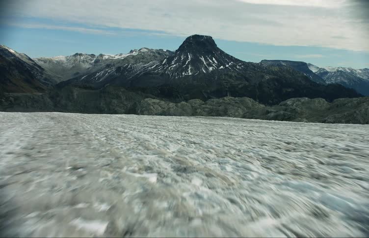 Aerial view of the surface of a glacier in the mountains