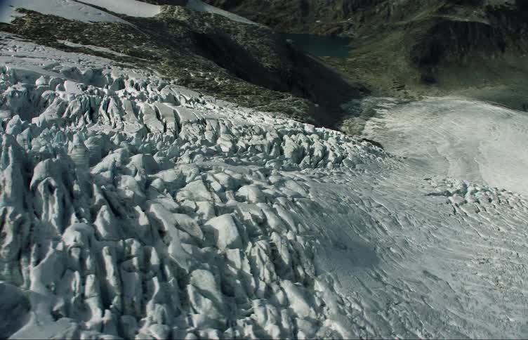 Aerial view of snow and ice covered mountain slope