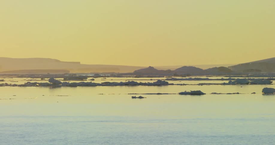 An icy body of water near sunset