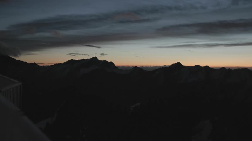 View of mountain ranges being silhouetted against the sky at dusk
