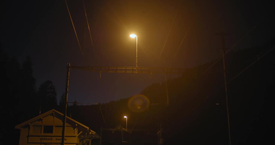 Single yellow streetlight over a home in a small town at night