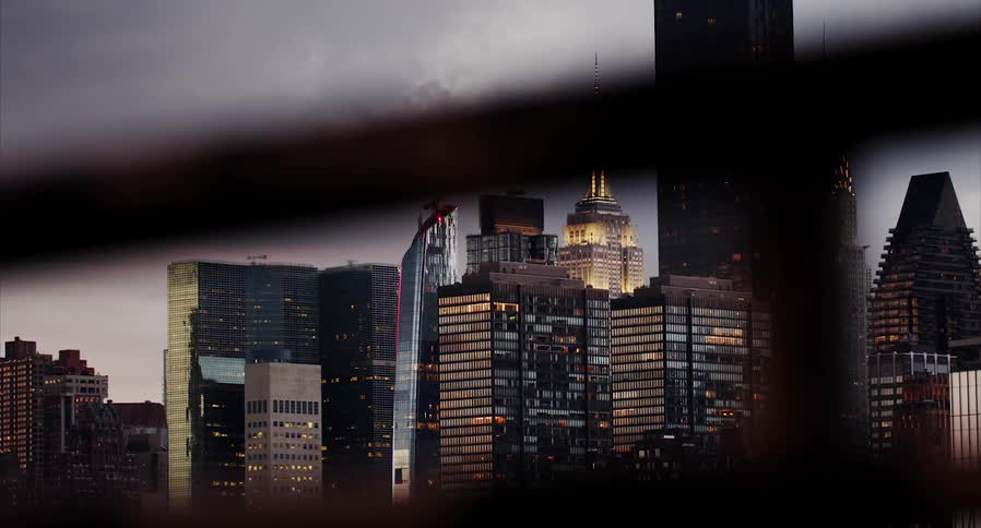 A city skyline with buildings and skyscrapers with the sky and clouds in the background
