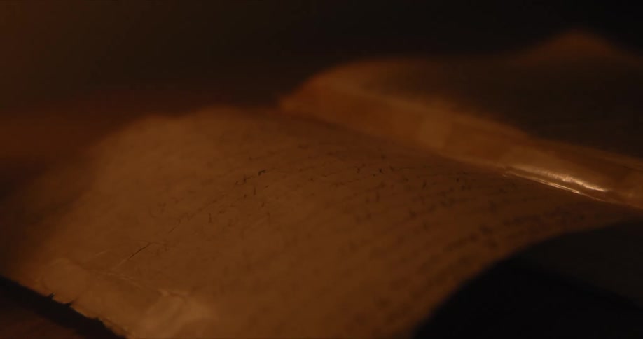 A book sits open in the dark room