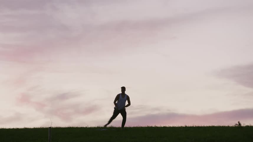 Silhouette of a man doing tai chi movements