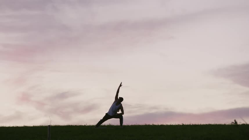 Silhouette of a man doing tai chi movements
