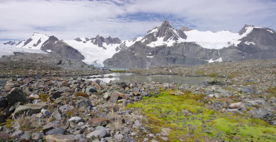 A small stream sits on a rocky range near a mountain