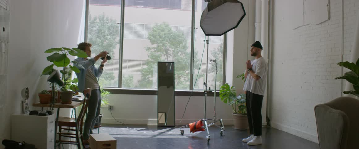 A man is posing for pictures in the photography studio