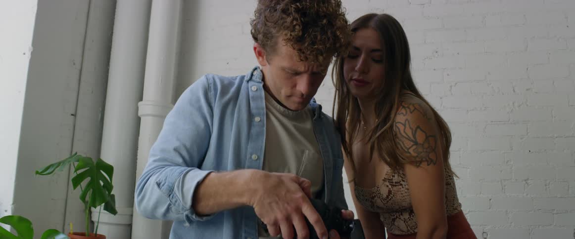 Photographer previews photographs with excited model