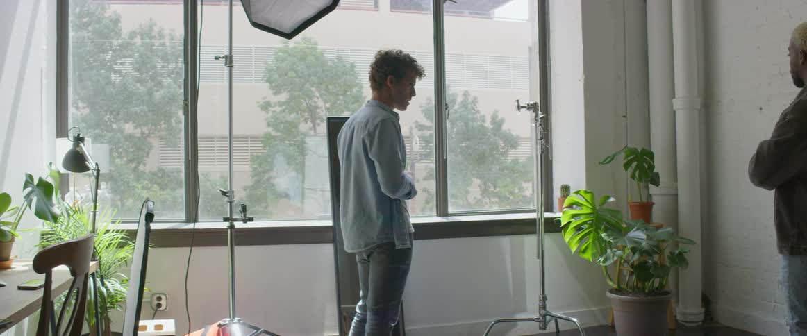 A photographer is setting up a shot with a model