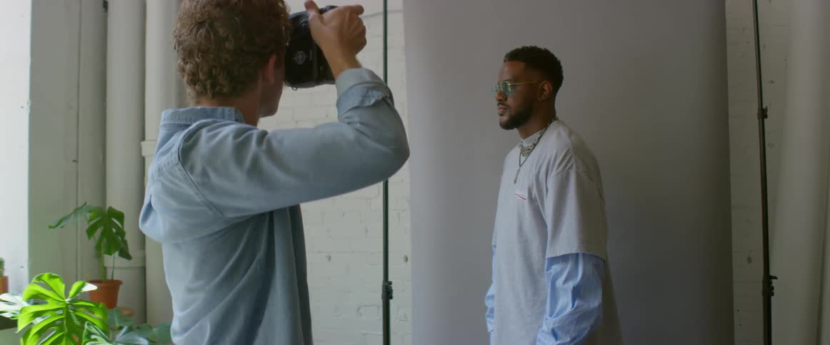 A photographer taking photos of a man