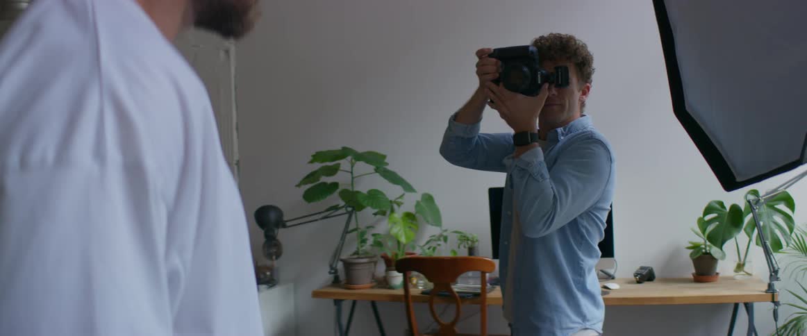 A man is being photographed with a large camera