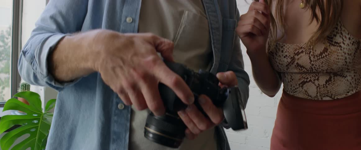 Young photographer shows pictures to a model inside a studio in the city