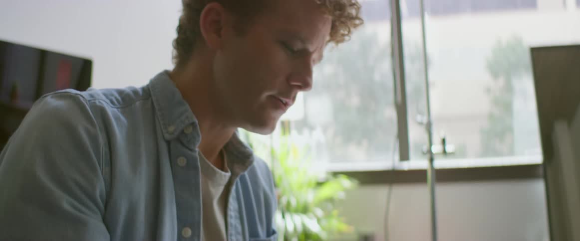 Young photographer uses a camera to take pictures inside an apartment