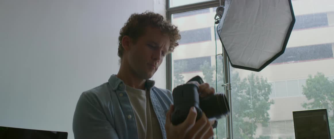 A man is taking photographs in his studio
