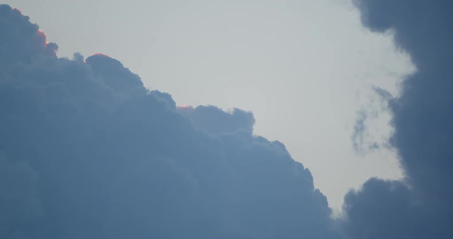 Sunlight reflecting on the edges of clouds as they move across the sky