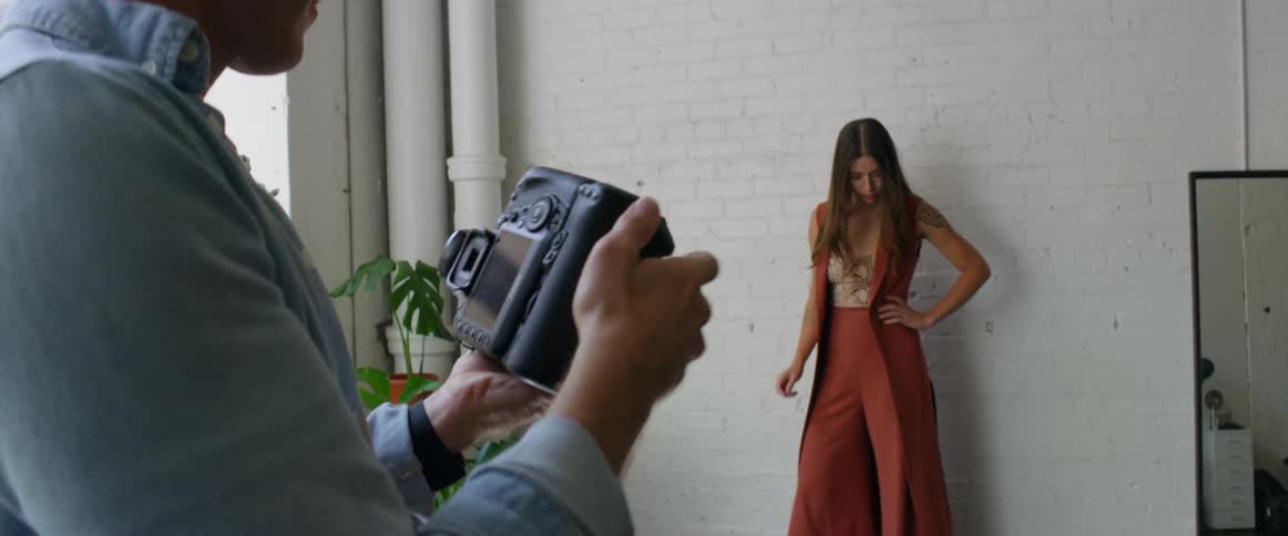 A man photographing a woman