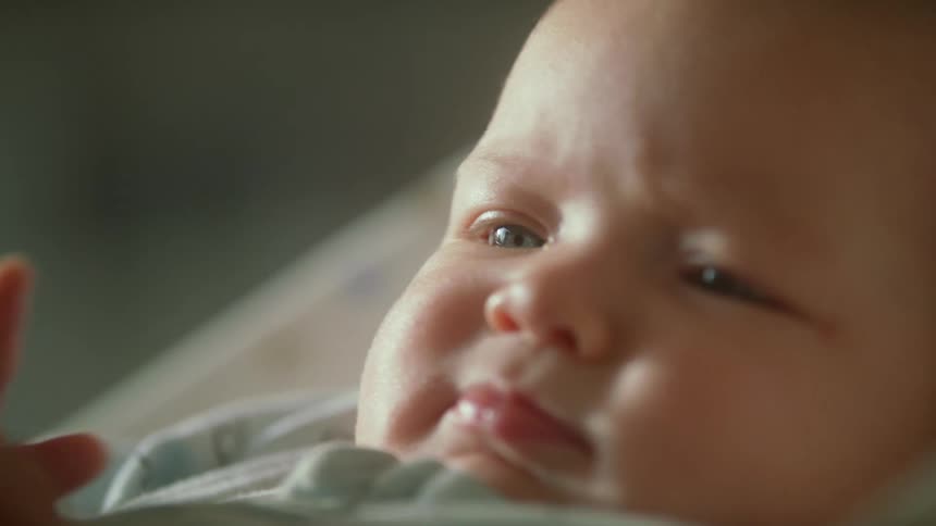 A baby laying in a bed