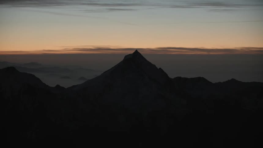 A silhouetteof a mountain at dawn