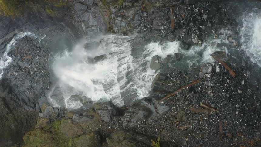 A waterfall down a cliff in the wilderness during the day