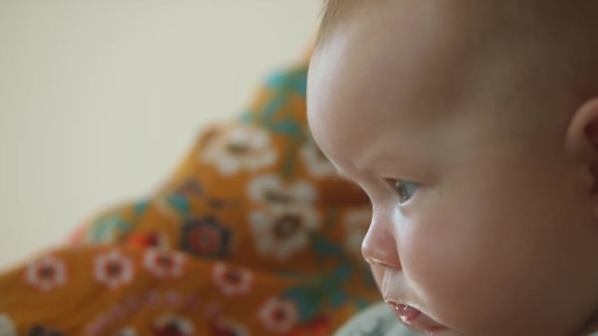 A baby is looking around and seems bored