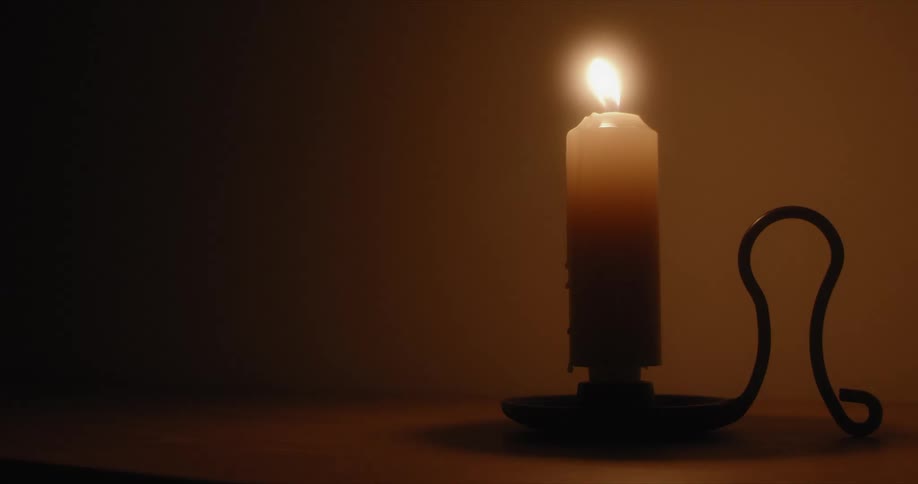 The flame of a candle flickers as it burns