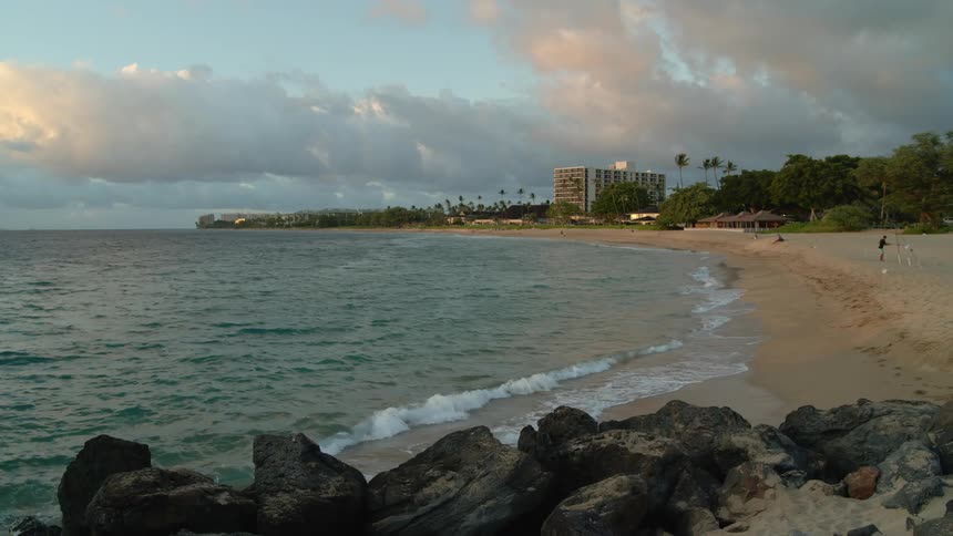 Some people are on the beach watching the water