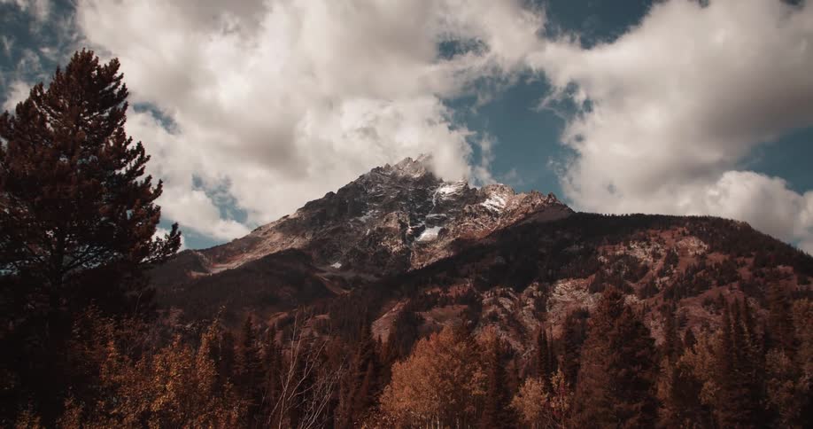Trees line the bottom of the mountain range