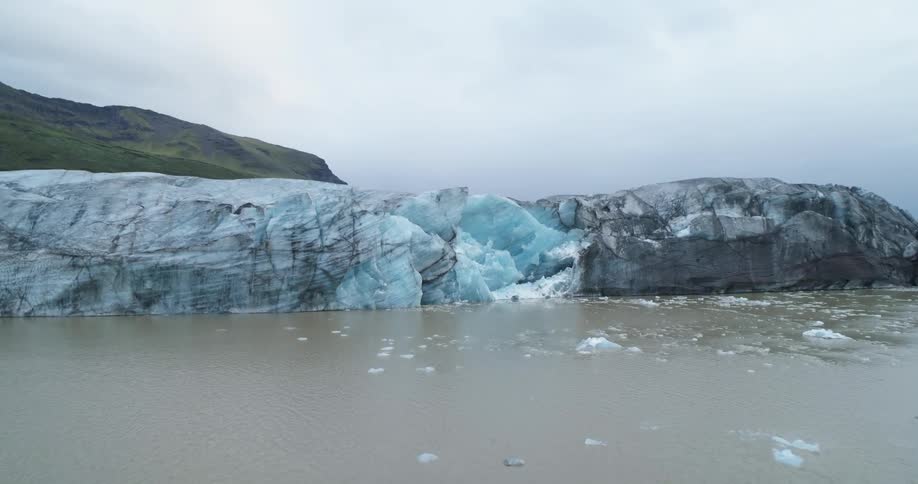 A view of a glacier outdoors on a lake