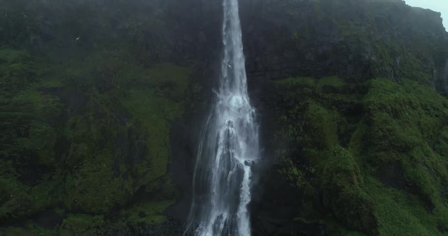 An aerial view of a waterfall on a mountain