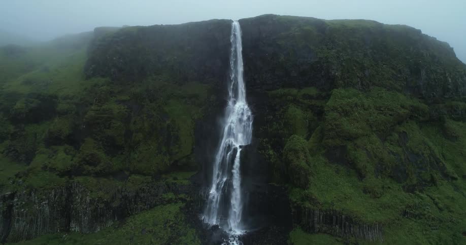An aerial view of a waterfall on a mountain